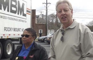 Phyllis Davis, general manager of the Hardee’s in Franklin, with Eddie Phillips, district manager. She’s getting ready to check off food supplies brought in by truck. Phillips was there making his rounds. He visits each of his six restaurants at least twice a week. -- STEPHEN H. COWLES/TIDEWATER NEWS