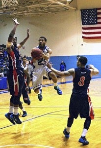 Mark Anthony Buright goes high in for a layup in the second half. -- FRANK DAVIS | TIDEWATER NEWS