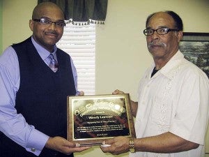 H. Gregory Reid, left, presents Waverly “Moses” Lawrence with a plaque of appreciation for his decades of service to Franklin youth. -- STEPHEN H. COWLES | TIDEWATER NEWS