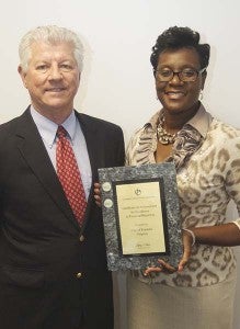 City Manager Randy Martin and Finance Director Melissa Rollins with the plaque. -- CAIN MADDEN | TIDEWATER NEWS