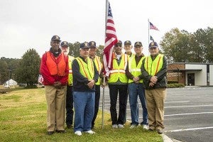 Every federal holiday, the members of the American Legion go around town and put up flags. The most recent outing was Veterans Day. From left, Joseph Bush, David Scott, David Flythe, Howard Vinson, David Davis, Duane Ashland, Wetlon Deshields and Chuck Williams. Members not pictured who contribute to the tradition are Johnny Jackson, Sammy Davis, Kenny Gay, Wayne Blythe and Larry Kilpatrick. -- Cain Madden | Tidewater News