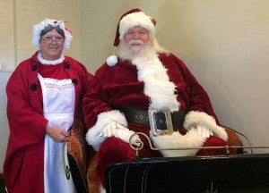 Santa and Mrs. Claus sitting in the new sleigh he bought that will be at the Elf Parade and the Christmas Parade this Thursday and Friday, respectively. -- Rebecca Chappell | Tidewater News