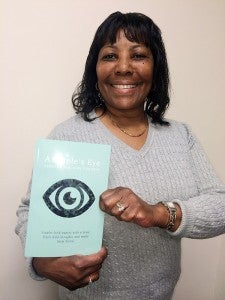 Rebeccca Faulkins holds a copy of her first book, “A Staple’s Eye,” which is a collection of poems she wrote, inspired by people in her life. -- Stephen H. Cowles | Tidewater News