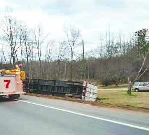 A tractor trailer narrowly avoided hitting a school bus flipped into a ditch on Wednesday. Eastbound Southampton Parkway was closed for roughly 45 minutes. -- SUBMITTED | MARILYN WALKER