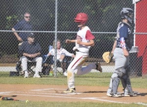 Bryan Johnson touches home plate after a double to left field scores two runs.