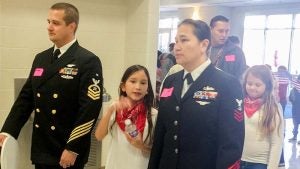 Servicemen and women were escorted to the assembly by fourth graders at Windsor Elementary School.