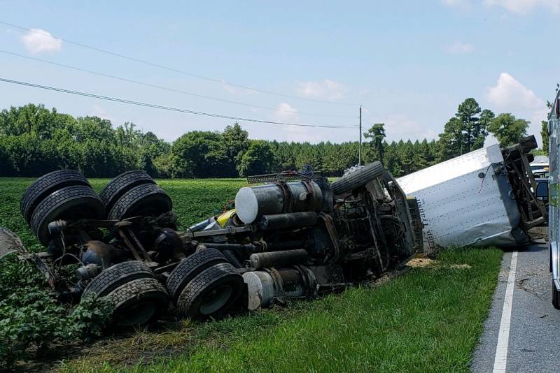 tractor trailer ovetrurns hugo road